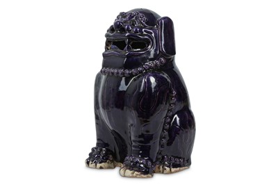 Lot 607 - A CHINESE AUBERGINE-GLAZED LION DOG. Qing...