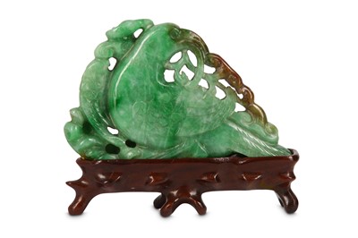 Lot 717 - A CHINESE APPLE-GREEN JADEITE ‘BIRD’ CARVING....