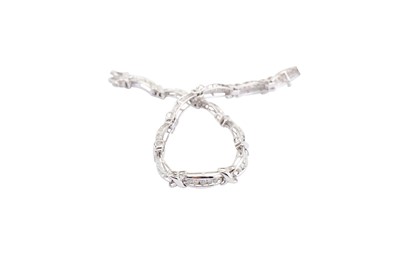 Lot 31 - A diamond bracelet, The polished links set...
