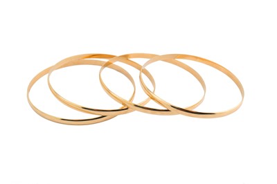 Lot 74 - A group of four bangles, Of plain D shaped...
