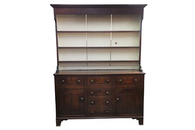 Lot 303 - A George III oak dresser, the plate rack with...