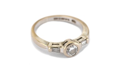 Lot 320 - A diamond single-stone ring, the collet-set...