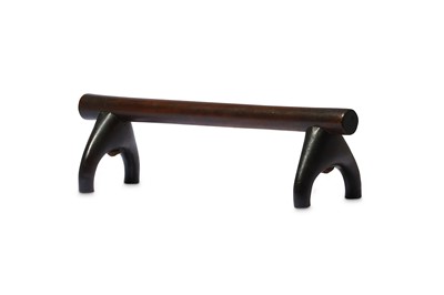 Lot 239 - A WOOD HEADREST With a dark, polished patina,...