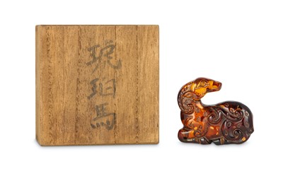 Lot 115 - A CHINESE GILT-SPLASH AMBER CARVING OF A RAM. ...