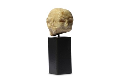 Lot 83 - AN ALABASTER SUMERIAN HEAD Circa 2200 B.C. The...