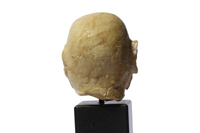 Lot 83 - AN ALABASTER SUMERIAN HEAD Circa 2200 B.C. The...