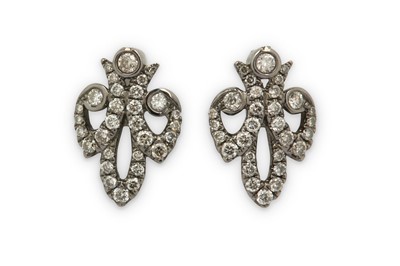 Lot 335 - A pair of diamond earrings, each designed as a...
