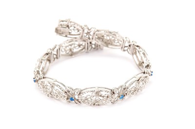 Lot 307 - A floral bracelet, set with blue paste...