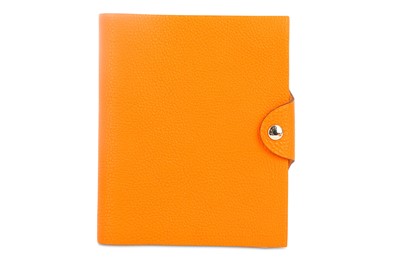 Lot 389 - Hermes Orange Togo Notebook, silver tone...