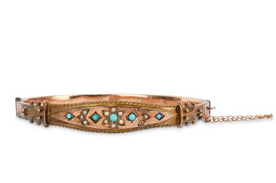 Lot 404 - A turquoise and seed pearl bangle,1906, the...