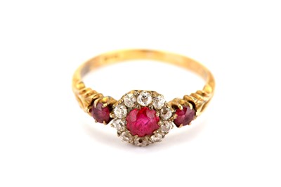 Lot 318 - A ruby and diamond cluster ring, the central...