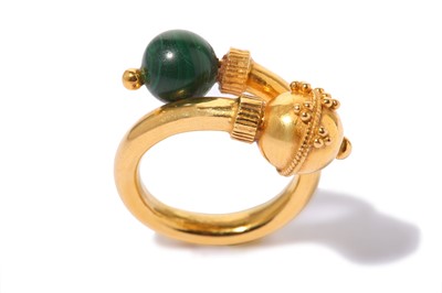 Lot 323 - A crossover ring, set with a malachite bead,...