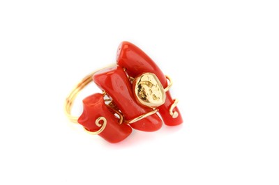 Lot 339 - A coral dress ring, set with three coral...