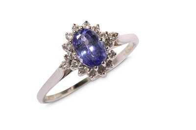 Lot 302 - A tanzanite and diamond cluster ring, the oval-...