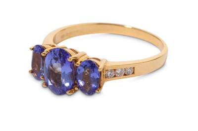 Lot 316 - A tanzanite three-stone ring, mounted in 18...