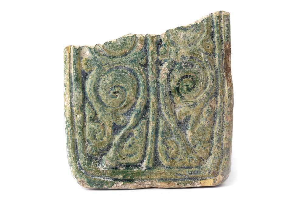 Lot 81 - A FRAGMENTARY GREEN-GLAZED POTTERY TILE WITH BIRDS AND VEGETAL ARABESQUE