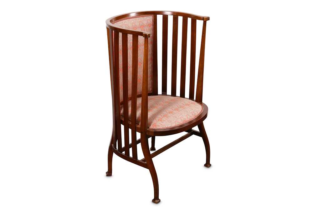 Lot 751 - An Arts and Crafts Liberty type walnut barrel...