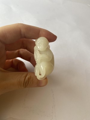 Lot 126 - A CHINESE WHITE JADE CARVING OF A MONKEY.