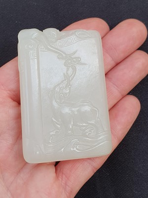 Lot 652 - A CHINESE PALE CELADON JADE 'MONKEY AND ELEPHANT' PLAQUE.
