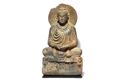 Lot 208 - A CARVED GREY SCHIST FIGURE OF A SEATED BUDDHA