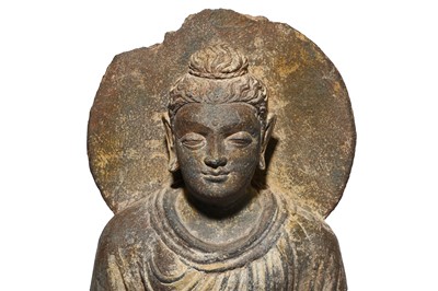 Lot 208 - A CARVED GREY SCHIST FIGURE OF A SEATED BUDDHA