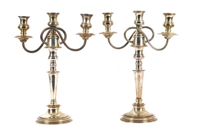 Lot 251 - A pair of silver plated three candle...
