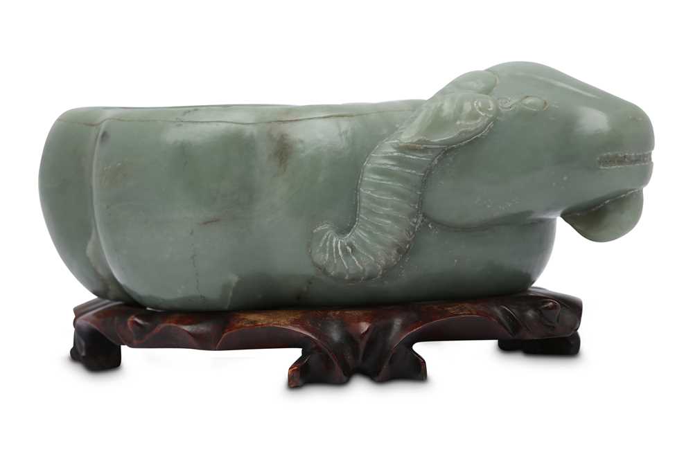 Lot 589 - A CHINESE PALE CELADON JADE 'RAM' WASHER.