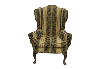 Lot 411 - A late 19th Century wing back armchair in gold...