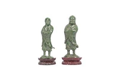 Lot 255 - TWO CHINESE SPINACH-GREEN JADE FIGURES OF LUOHANS.