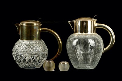 Lot 288 - Two silver plated and glass water jugs, each...