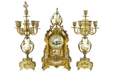 Lot 98 - A French gilt metal clock garniture with...
