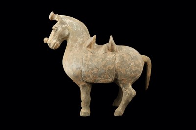 Lot 330 - A CHINESE POTTERY MODEL OF A SADDLED HORSE