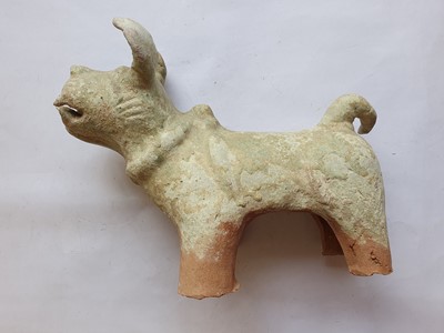 Lot 38 - A CHINESE GREEN-GLAZED MODEL OF A DOG.
