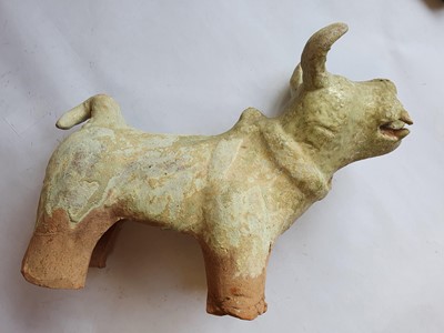 Lot 229 - A CHINESE GREEN-GLAZED MODEL OF A DOG.