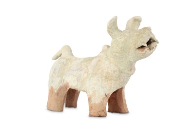 Lot 402 - A CHINESE GREEN-GLAZED MODEL OF A DOG.