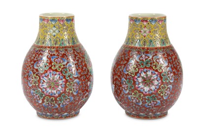 Lot 239 - A pair of pink ground Chinese famille rose vases.