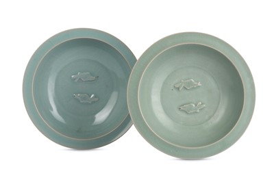 Lot 322 - TWO CHINESE CELADON-GLAZED 'TWIN FISH' DISHES....