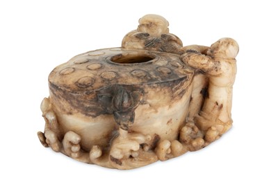 Lot 497 - A CHINESE CREAM JADE 'LOTUS AND BOYS' WASHER