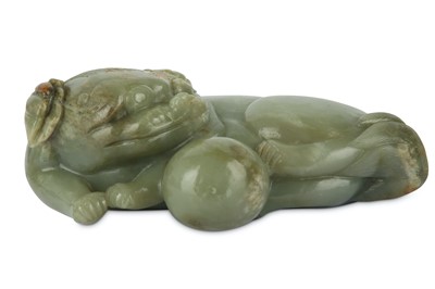 Lot 182 - A CHINESE PALE CELADON CARVING OF A LION DOG WITH A BALL.