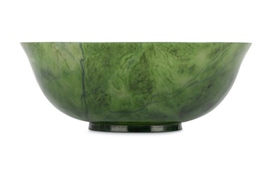Lot 143 - A CHINESE SPINACH-GREEN JADE BOWL. The gently...