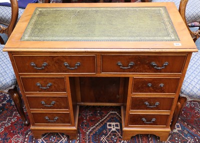 Lot 362 - A ladies yewwood kneehole desk with tooled...