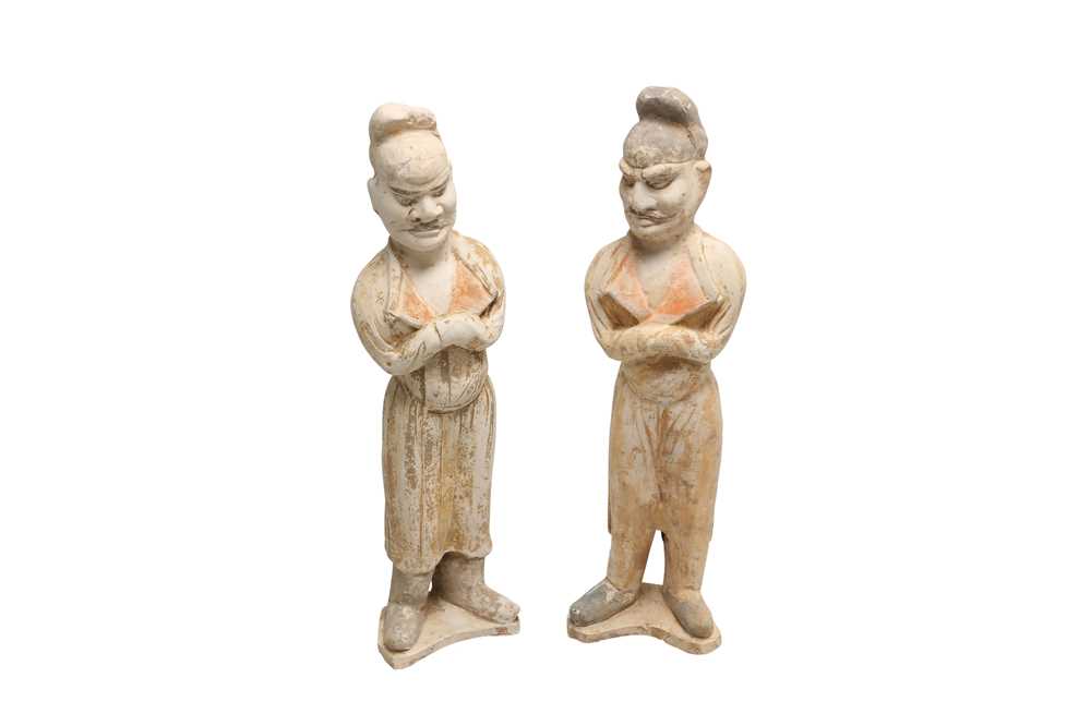 Lot 557 - A PAIR OF LARGE CHINESE POTTERY GUARDIAN FIGURES.