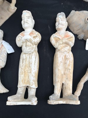 Lot 557 - A PAIR OF LARGE CHINESE POTTERY GUARDIAN FIGURES.