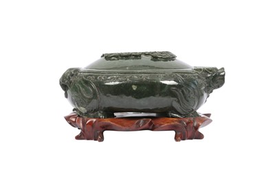 Lot 741 - A CHINESE SPINACH-GREEN JADE 'DRAGON' VESSEL AND COVER.