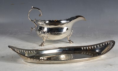 Lot 323 - A Georgian hallmarked silver sauceboat on pad...