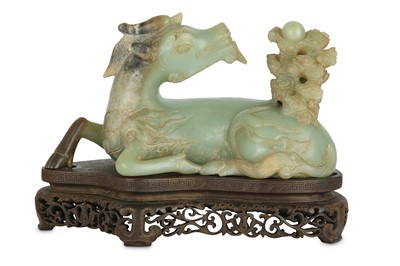 Lot 552 - A CHINESE PALE CELADON JADE CARVING OF A QILIN....
