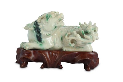 Lot 189 - A CHINESE APPLE-GREEN JADEITE CARVING OF A QILIN.
