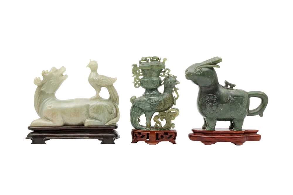 Lot 697 - TWO CHINESE SPINACH-GREEN JADE 'ANIMAL' VESSELS AND COVERS AND A JADE QILIN CARVING.
