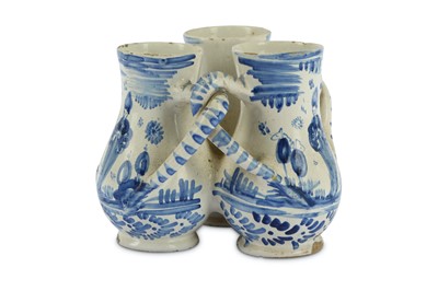 Lot 60 - A German fayence blue and white fuddling cup,...