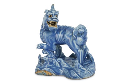 Lot 557 - A CHINESE BLUE-GLAZED BISCUIT MODEL OF A QILIN....